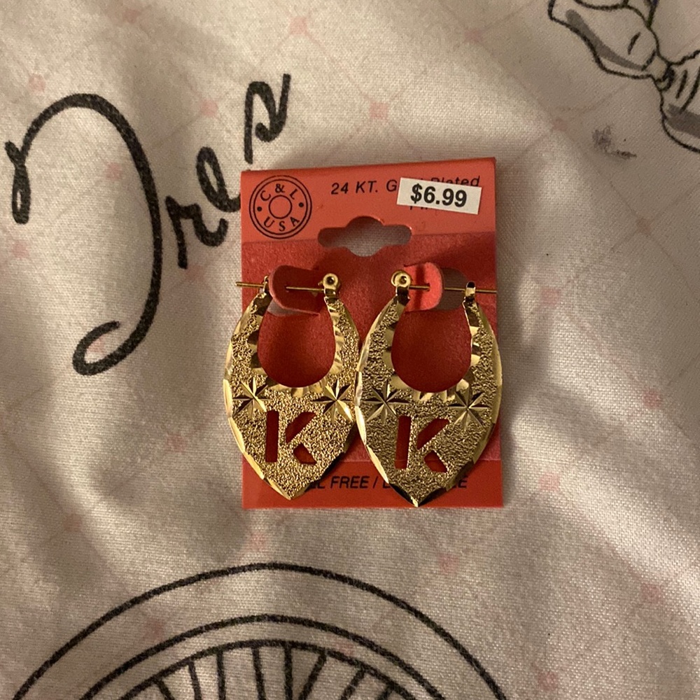 Earrings with a k on them